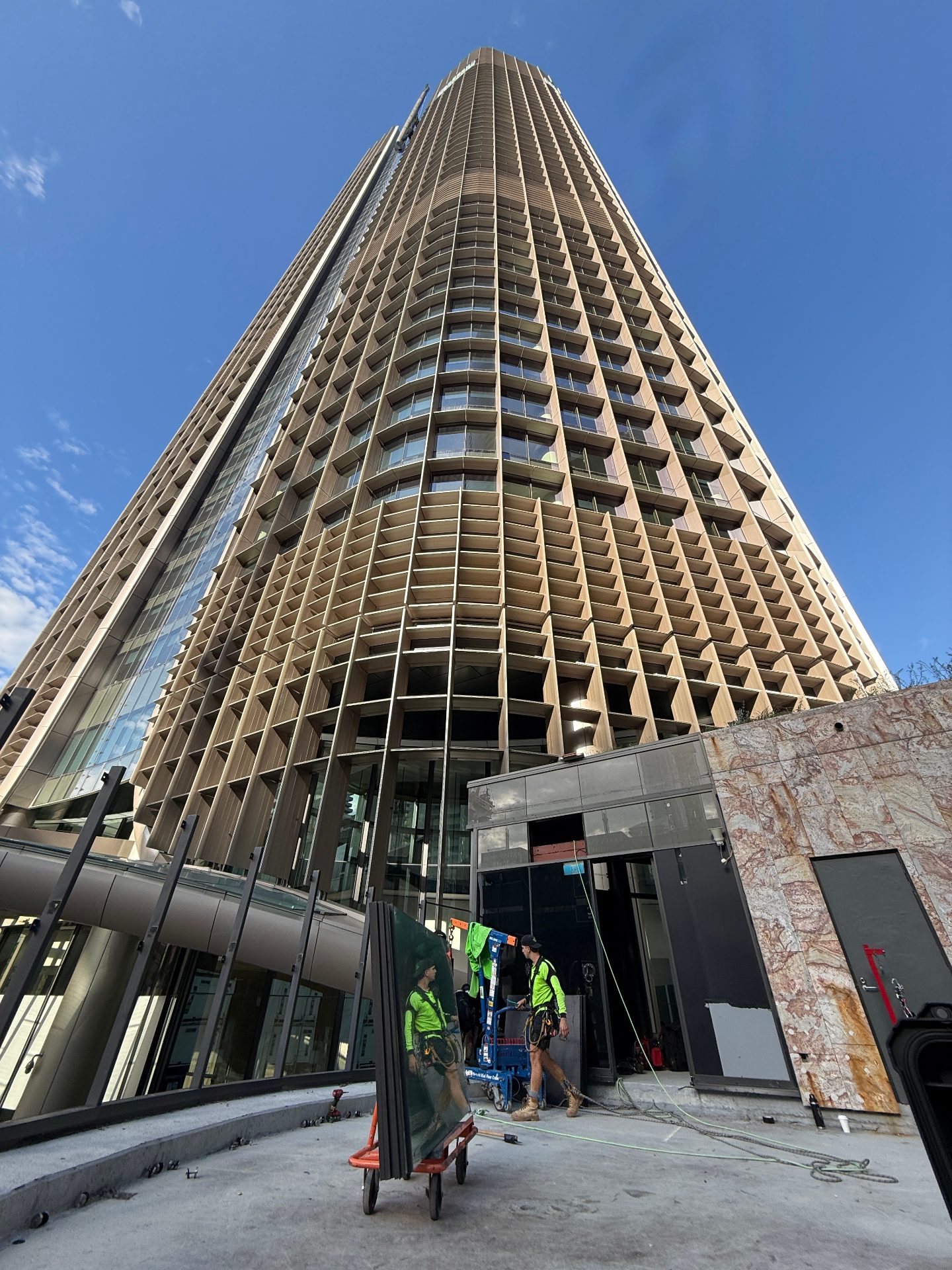 Looking up the curved bronze-louvred façade of 1 William Street tower in Brisbane CBD